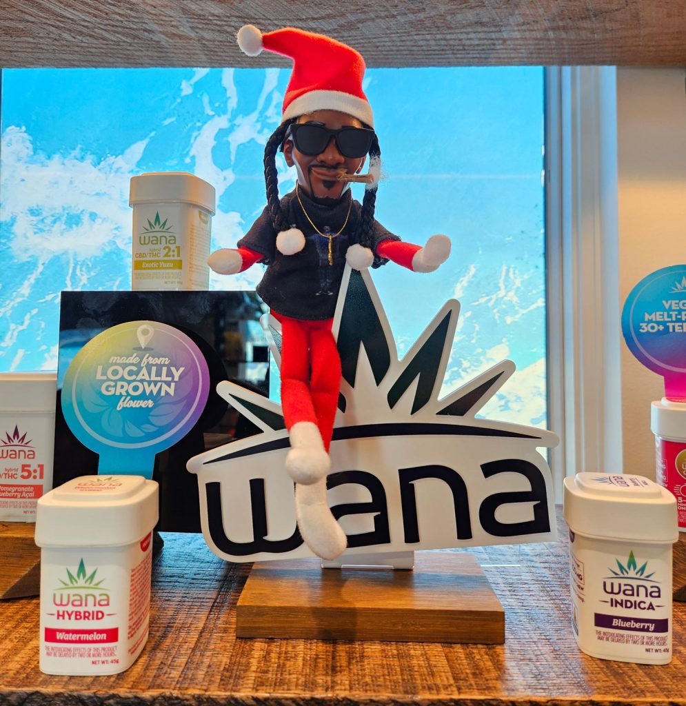 Holiday display at Shore House Canna in West Cape May featuring Wana edibles and a festive Snoop Dogg elf figure sitting on a Wana sign